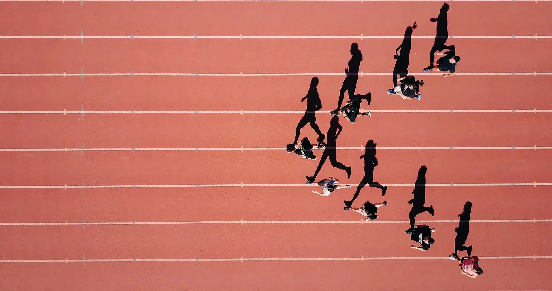 top down view of runners racing on a running track